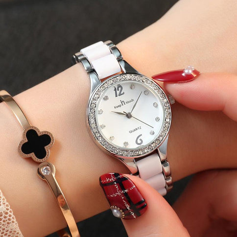 Elegant female wrist watches featuring a silver and white design with sparkling details and a stylish bracelet