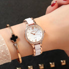 Elegant female wrist watch featuring a rose gold case, white strap, and sparkling diamond accents for luxurious style.