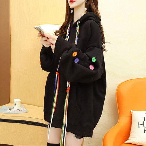 Black Korean style stitching button blouse featuring colorful buttons and drawstring hood for a trendy look