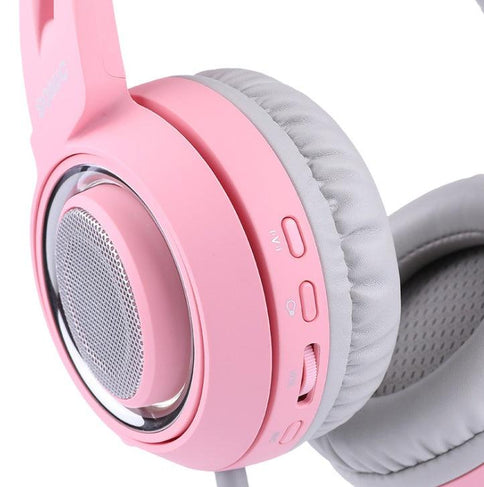 G951 USB gaming headset in pink with soft ear cushions, LED lights, and volume controls for immersive sound experience