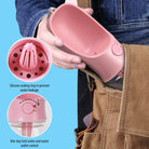 Portable pet water bottle in pink with a silicone sealing ring and one-key lock for easy water dispensing