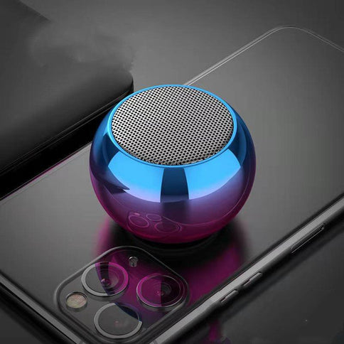 Compact portable Bluetooth speaker with a shiny blue and purple finish, designed for high volume outdoor use