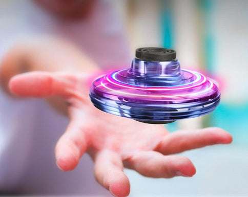 Mini fingertip gyro drone with LED lights, hovering above a hand, ideal as an interactive decompression toy