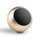 Compact portable Bluetooth speaker in gold with a sleek round design, ideal for outdoor use and high-volume sound.