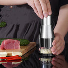 User pressing a stainless steel garlic crusher and onion chopper to finely chop vegetables, ideal for quick meal prep with a vegetable chopper and garlic press