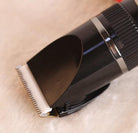 Close-up of LCD display USB electric clippers with a sleek black design and precision cutting blade for grooming tasks