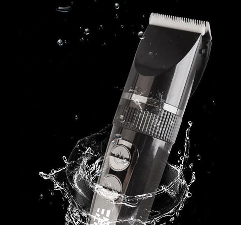 LCD display USB electric clippers surrounded by splashing water, showcasing a sleek design and user-friendly controls