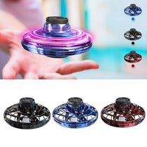 Colorful LED flying drone toy spinning above a hand, showcasing its interactive design in blue, black, and red