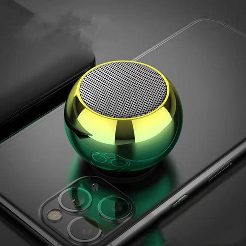 Compact portable Bluetooth speaker with a shiny green exterior, perfect for high volume outdoor use