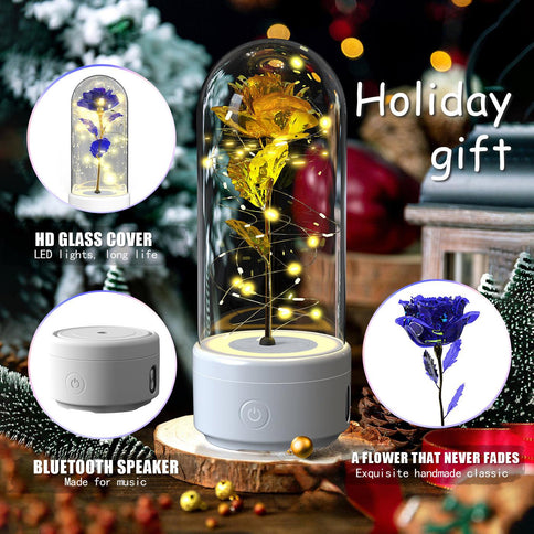 Bluetooth rose flowers LED light with a vibrant blue rose under a glass dome and a Bluetooth speaker base for music.