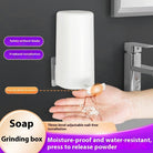 Wall mounted soap grinder installed on a wall, dispensing grated soap into a hand for convenient and tidy use