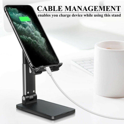 Adjustable cell phone stand featuring cable management for convenient device charging while in use