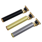 Three professional electric hair clippers featuring engraved designs in black, gold, and silver for precision grooming and styling