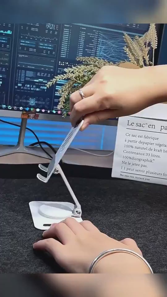 Adjustable phone holder with 360-degree rotation, perfect for use on a desk with a computer monitor